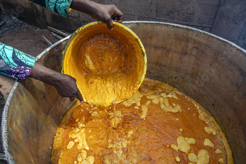 Villager making palm oil in Dokoue, Benin