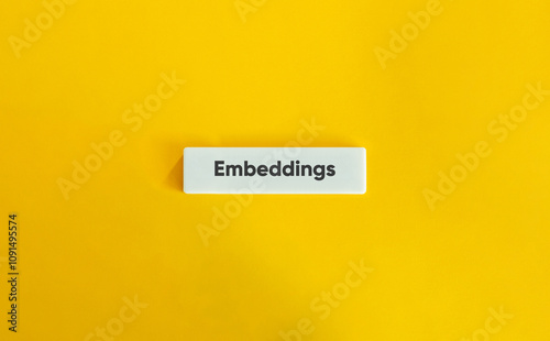 Embeddings Keyword in Generative AI. Text on Block Letter Tile on Yellow Background. Minimal Aesthetic.