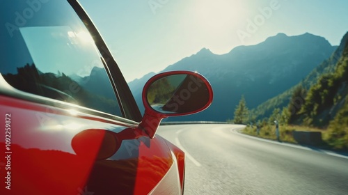 Reflective car wing mirror capturing majestic mountains and bright sunlight on a scenic winding countryside road during a road trip.