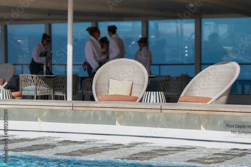 Outdoor Swimmingpool with wake aft deck views and lounge sun loungers and deck chairs furniture on modern luxury ocean liner cruiseship cruise ship