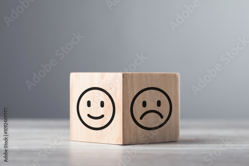 Wooden blocks displaying a sad face transitioning to a happy face, symbolizing a shift from negativity to positivity. Final block turns from sad to happy, highlighting the power of a positive outlook