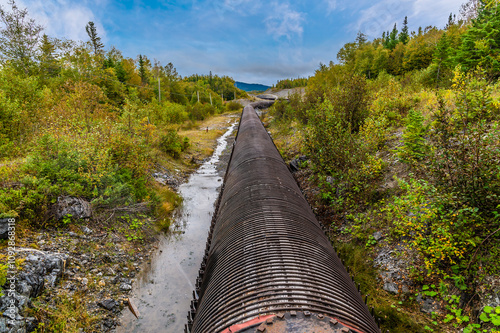 A view along the length of a wooden-stave water pipe above Corner Brook in Newfoundland, Canada in the fall 