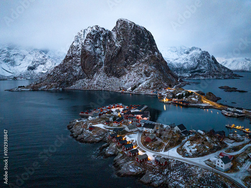 Stunning Aerial View of SnowCovered Mountain and Serene Waters Surrounded by Natures Beauty