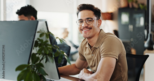 Computer, portrait and web development with smile of man in creative workplace for coding or design. Cybersecurity, happy and system infrastructure with employee person in office as website developer