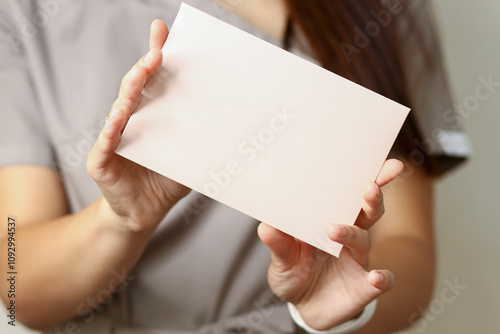 female hands hold a blank postcard,card