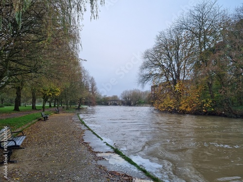 Cold early morning by the river with foaming water over the weir