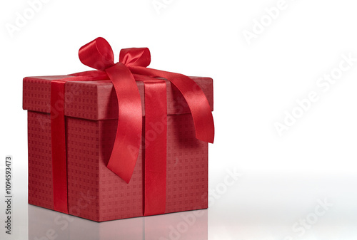 A beautiful dark red gift box with a charming red ribbon on a white