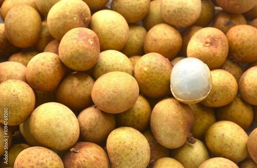 close up of longan tropical fruit peeling out in batch background and texture