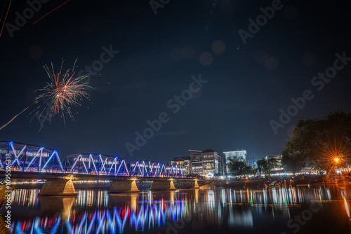  fireworks show at iron bridge across ping river where decorate with a lot of colorful light lanterns is highlight of yee peng loy krathong festival chiangmai thailand November 2024