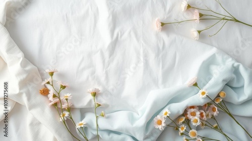 White fluffy cotton flowers scattered on blue sheet, environmentally natural fabrics, clothing, pastel linen, linen, sheet