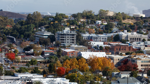 An 16x9 format image of the city of Martinez, California. The government buildings can be seen as well as an Amtrak train. 