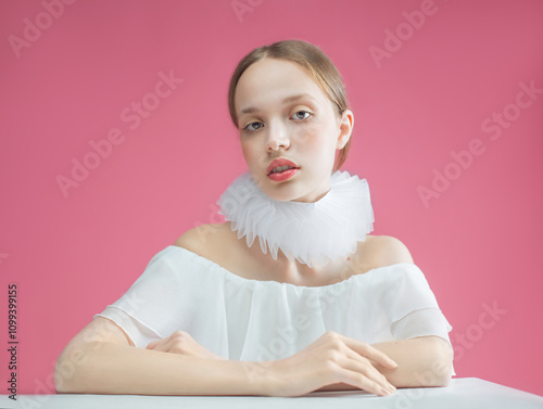 Beautiful girl in a white dress with a jabot around her neck