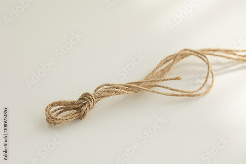 brown string is laying on a white background.