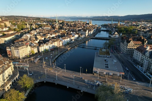 Aerial view of Zurich with historic architecture and mountain backdrop.