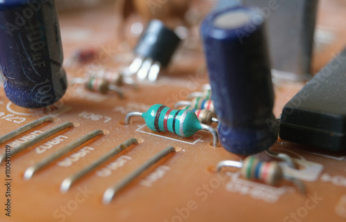 Components mounted on an electronic board. Focused on green axial inductor.