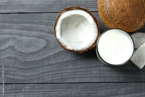 Glass of coconut milk on wooden background 