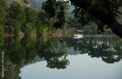  A tourist riverboat plies it s trade on the beautiful and calm Dalyan River in southern Turkey