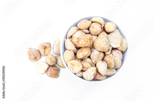 Candlenut or Aleurites moluccanus in a white bowl isolated on white background. Candlenuts are a cooking spice