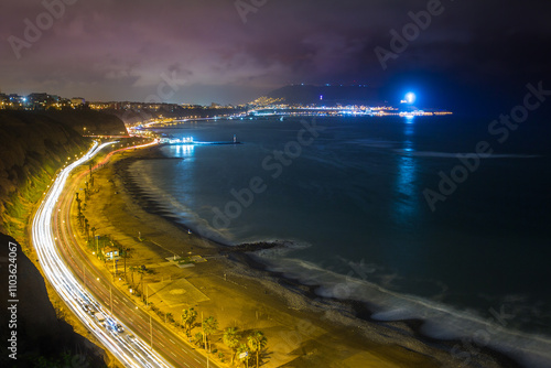 La Costa Verde under the night sky.The city lights dance along the coast, waves softened into mist with the long exposure, creating a dreamscape that feels otherworldly. Miraflores Lima Peru