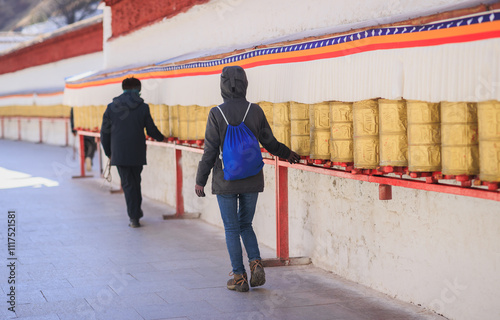 One Tibetan lady Spin the Tibetan Prayer Wheels in Potala place,Lhasa,China