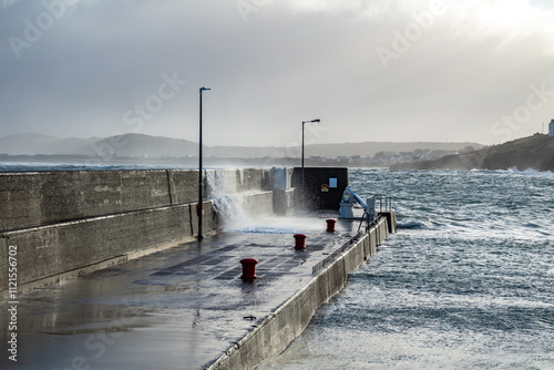 Waves crashing against the pier at Portnoo harbour after Storm Franklin - County Donegal, Republic of Ireland