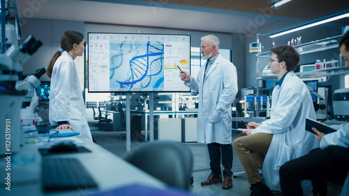 Diverse Team of Scientists Discussing Ideas in a Biotech Startup Lab. Group of International Students Listening to Their Science Professor While He Shows DNA Sequencing Method on a TV Screen