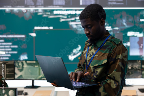 Technical engineer monitoring surveillance system from CCTV to track any hostile aircrafts, working in federal reconnaissance division bureau to ensure national safety. Big screen and high tech.