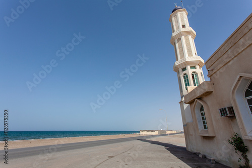 Minaret of the Barka mosque and sea view in Barka, Oman, Middle East