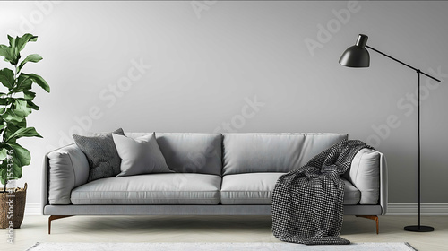 Generate an image of a modern minimalist living room with a gray couch positioned against a light gray plain wall To the right of the couch is a floor lamp with a b