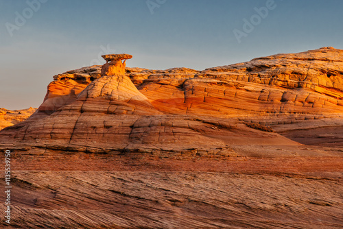 A hoodoo formation surrounded by sandstone shapes along the Beehive Trail near Page, Arizona.