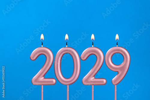 Happy new year 2029 - Candles in the shape of a number on a blue background