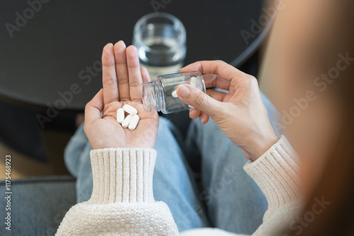 Sick asian young woman, girl holding tablet pill on hand pour capsule from medication bottle, painkiller medicine from stomach pain, head ache, pain for treatment, take drug or vitamin, health care.